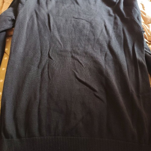 Black sweater used, medium size with loose fit and small hole