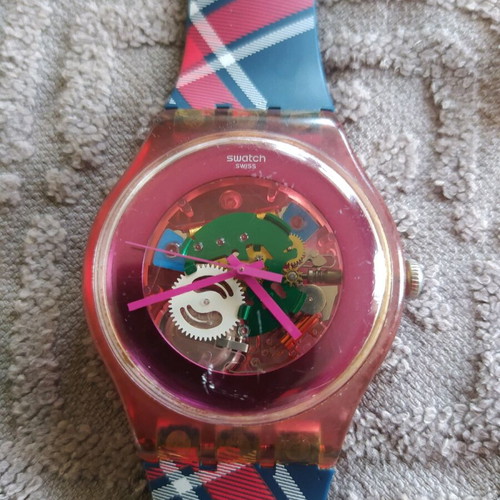 Swatch unicex watch used with transparent case and pink plastic strap
