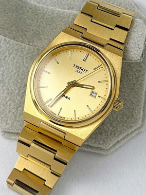 Tissot PRX Quartz watch with golden dial