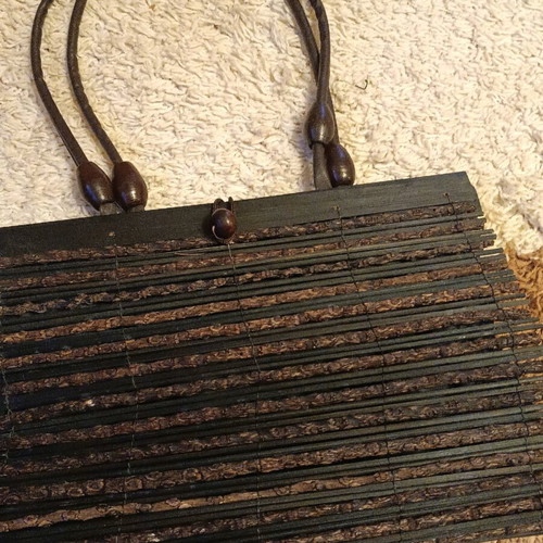 Wooden bag with slightly faded strap