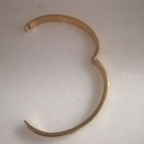 Steel bracelet with clip and rhinestones, gold color