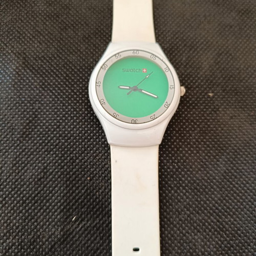 Swatch watch used with white silicone strap and green dial