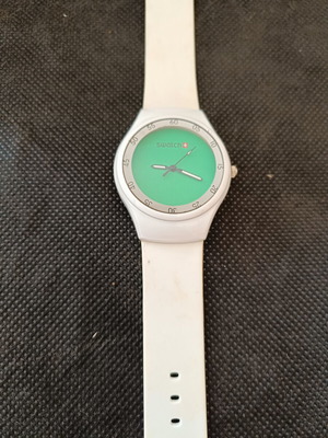 Swatch watch used with white silicone strap and green dial