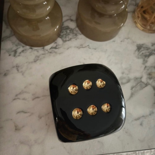 Decorative black dice with gold dots