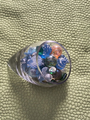 Glass decorative piece with blue sea-themed marbles and stones