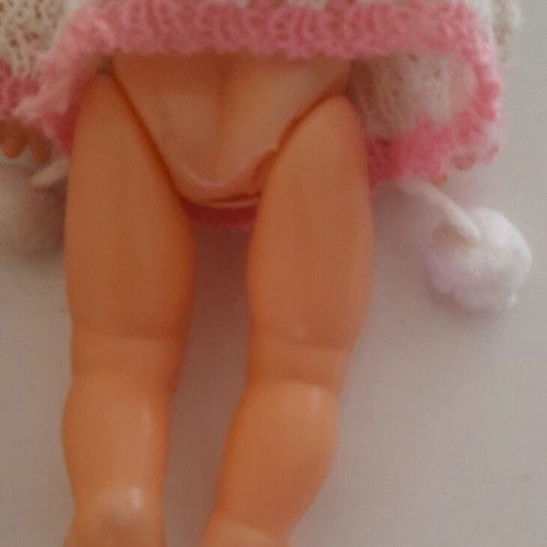 Vintage plastic baby doll from the 70s used with handmade sweater and hat
