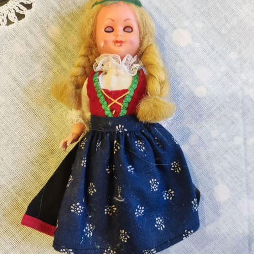 Retro doll used with traditional costume and broken leg