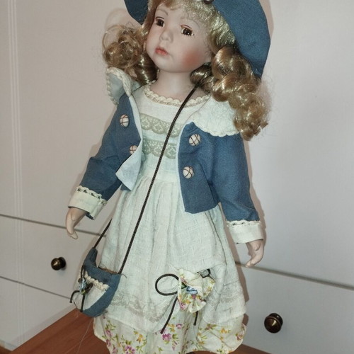 Porcelain doll rare, new with hat and dress