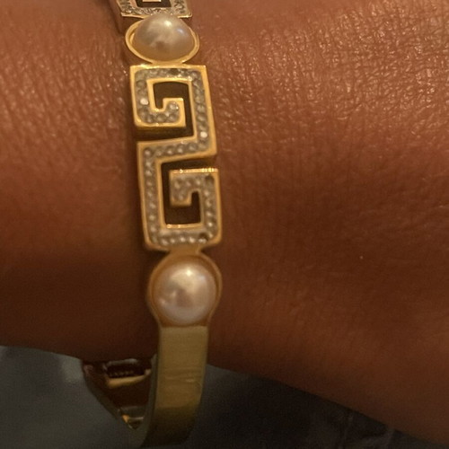 Steel bracelet used, gold color with meander design, crystals and pearls