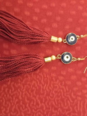 Earrings with red tassel and blue eye like new