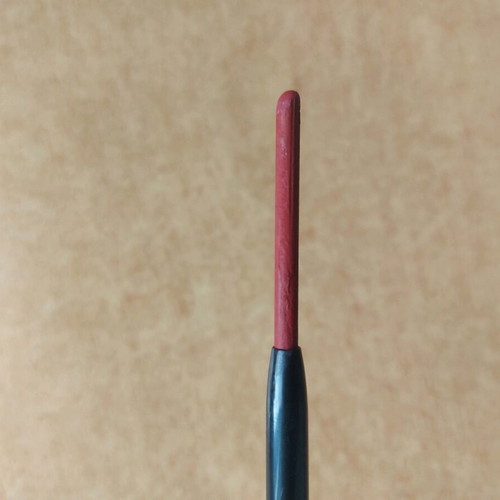 Mechanical lip pencil used, deep red with sharpener