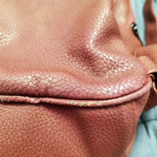 Backpack used red bag with quilted front zipper