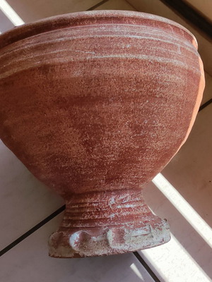 Clay flowerpot used with crack at base