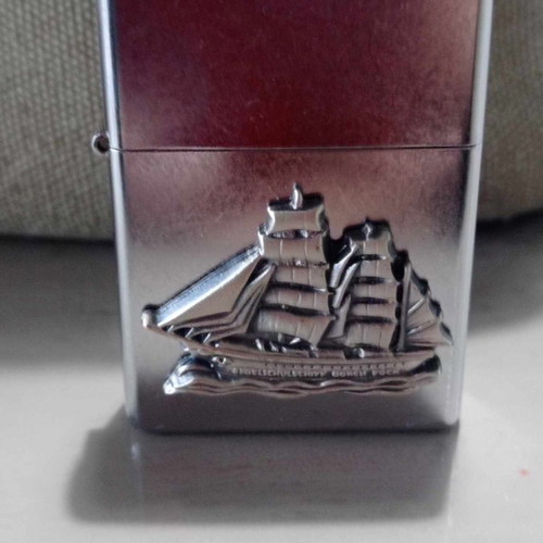 Zippo lighter with carved ship design