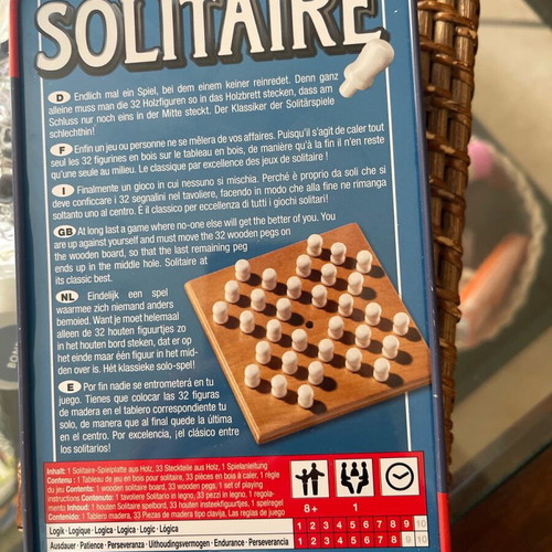 Solitaire game like new with wooden board and pegs in tin box