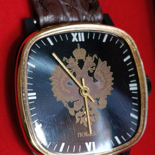 Pobeda vintage Soviet Russian mechanical watch with square case and double-headed eagle emblem