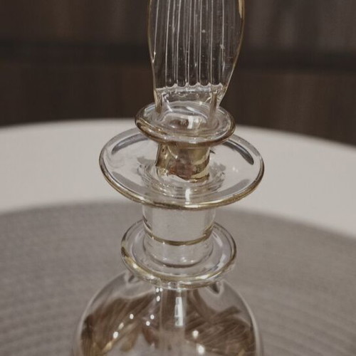 Glass perfume bottle used with golden accents and cap