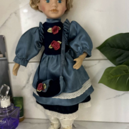 Porcelain doll like new vintage with blue satin dress