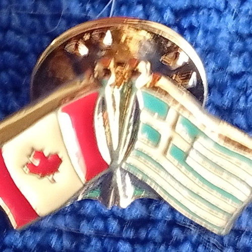 Metal lapel pin with crossed flags of Greece and Canada, new