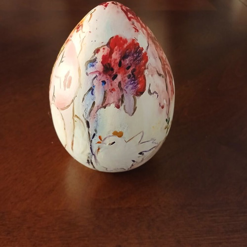 Hand-painted ceramic egg with floral and female figure design