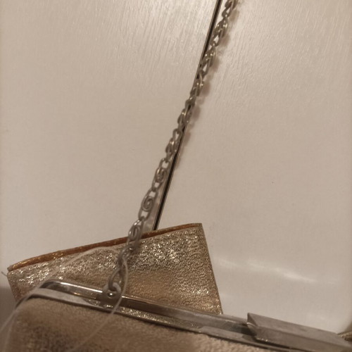 Gold evening bag with chain for crossbody use