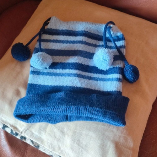 Knitted striped kids hat used, blue and turquoise