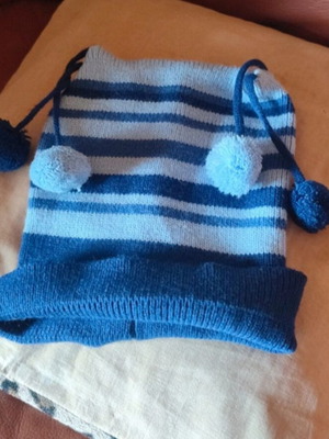 Knitted striped kids hat used, blue and turquoise