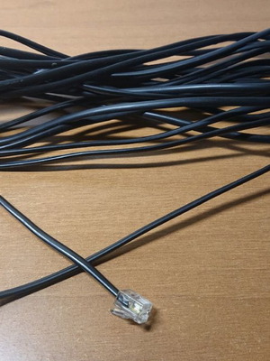 Telephone cable used 6 meters with 2 plugs black