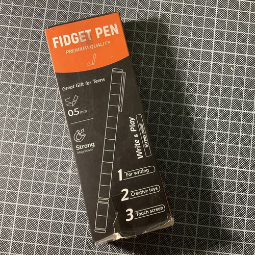 Gold Fidget Pen used with magnetic parts and two ink refills