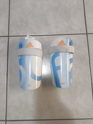 Adidas F50 Lite shin guards used with adjustable straps