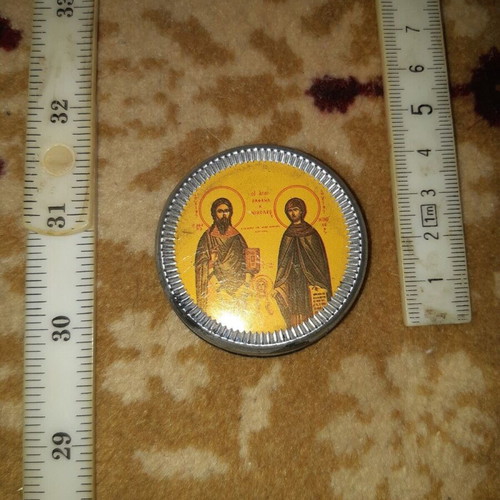 Metal amulet used with saints Raphael and Nicholas