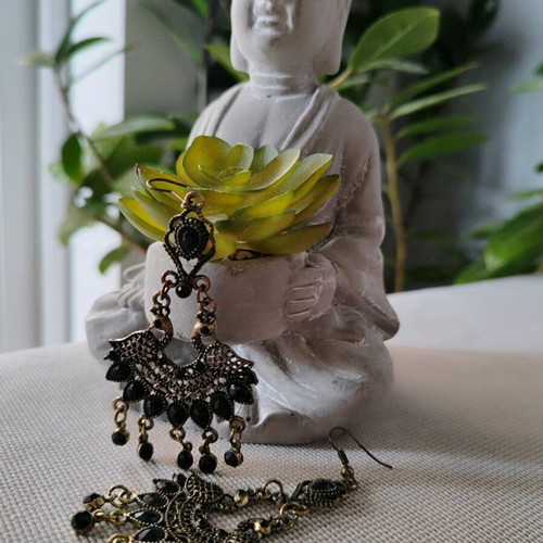 Long metal earrings used, black and gold