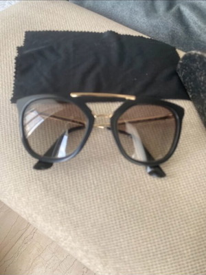 Prada sunglasses in black with gold details