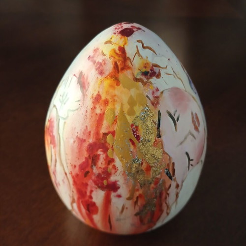 Hand-painted ceramic egg with floral and female figure design