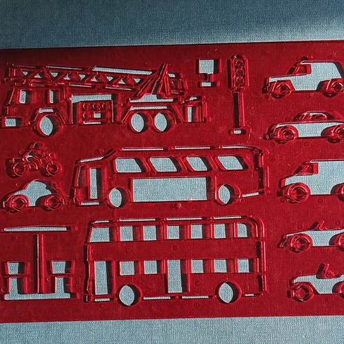 Red plastic stencil with vehicle designs