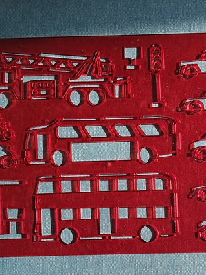 Red plastic stencil with vehicle designs