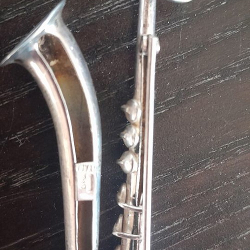 Saxophone-shaped silver pin like new