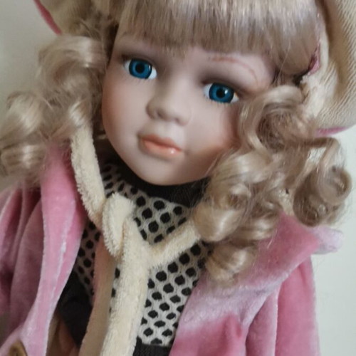 Collectible doll with coat and handbag like new