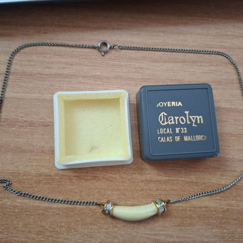 Necklace with ivory tusk pendant used, gold caps and strass decoration