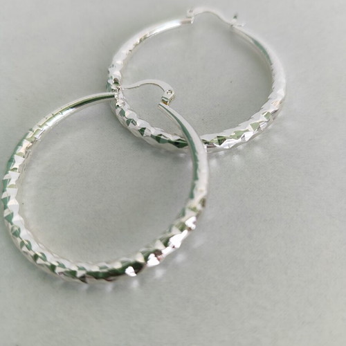 Silver-tone hoop earrings like new with diamond-cut texture