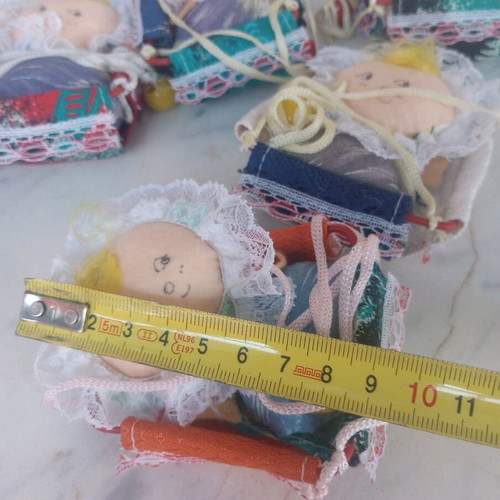 Seven cloth baby dolls in cradle new