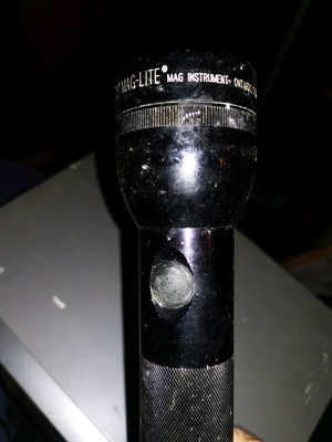 American Maglite flashlight used, takes 2 batteries