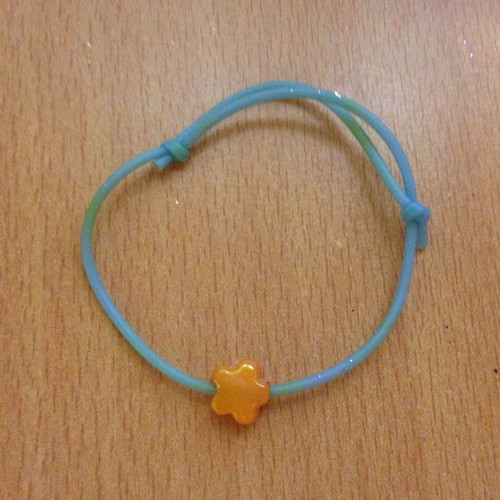 Turquoise bracelet with orange flower bead used