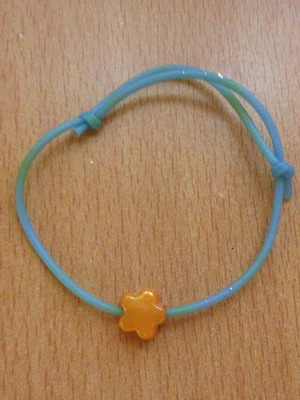 Turquoise bracelet with orange flower bead used