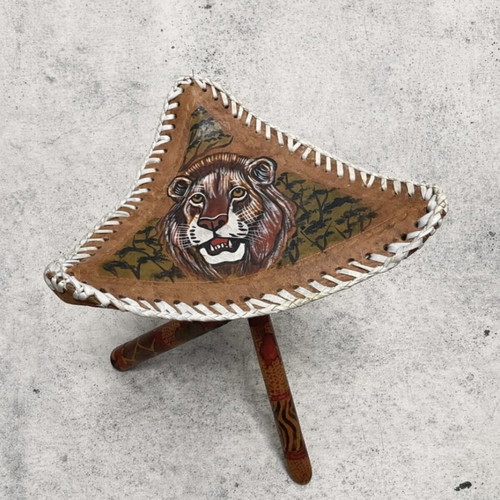 Handmade tripod stool used with leather seat and carved wooden legs