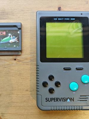 Supervision 9169 used with game, handheld console