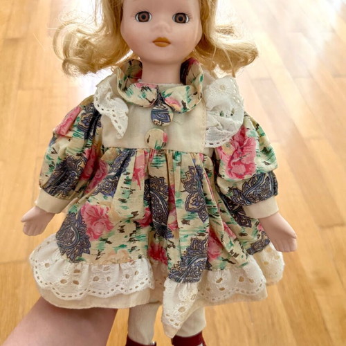 Porcelain doll like new with colorful dress and straw hat
