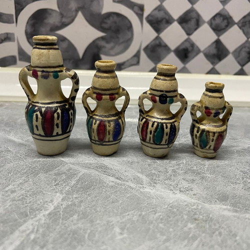 Set of four used vintage hand-painted porcelain vases