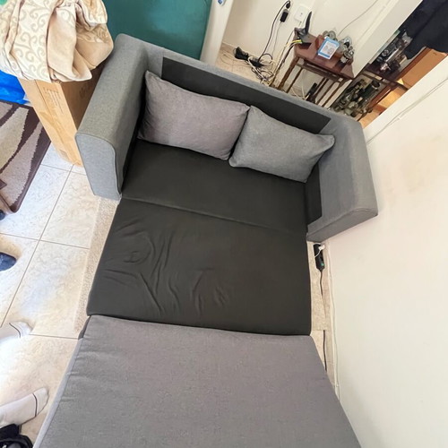 Two-seater grey sofa bed