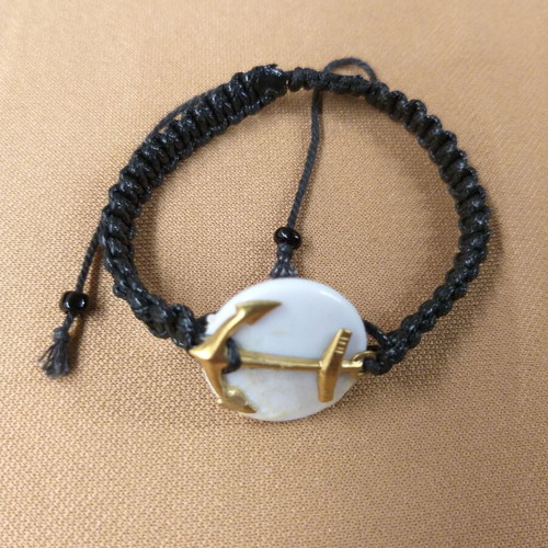 Macrame bracelet with gold anchor on white base
